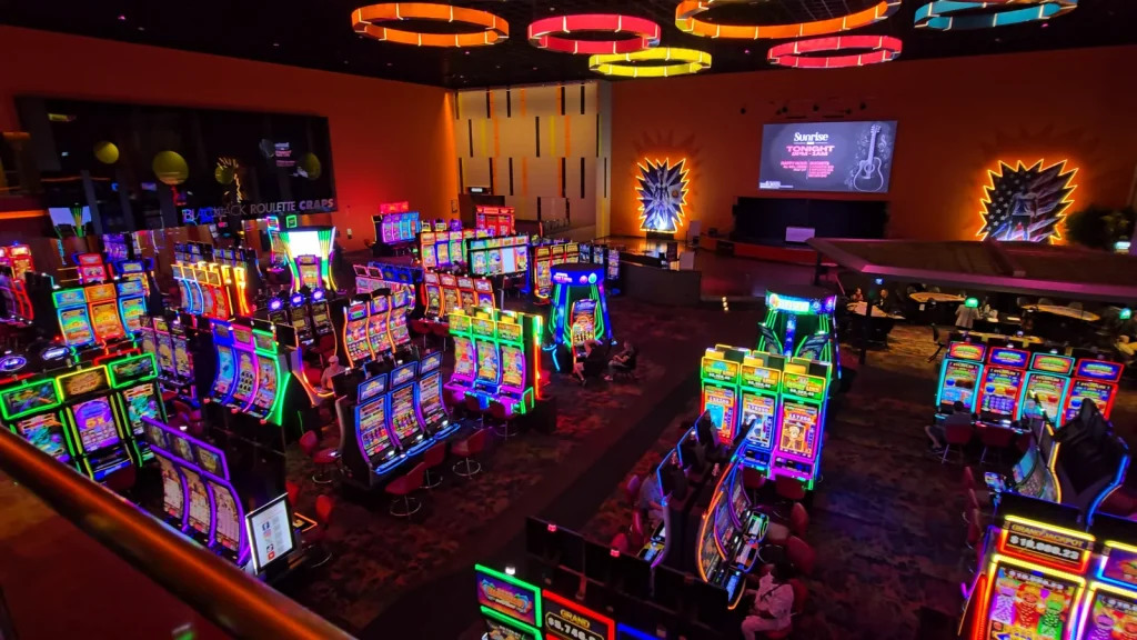 Wide elevated view across the colorful slot floor at The Casino @ Dania Beach.