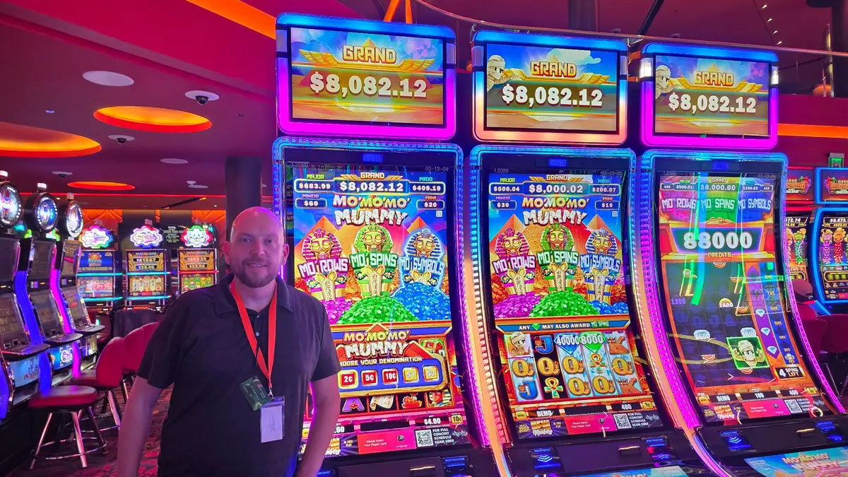 Wojtek beside a bank of Mo’ Mo’ Mo’ Mummy slot machines at The Casino @ Dania Beach.